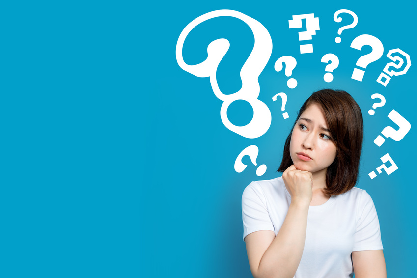 young woman with question marks.